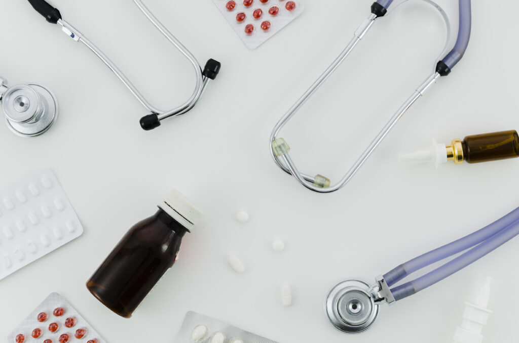 Stethoscope, pills, nasal spray and bottle